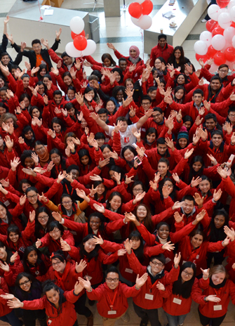 Students give a Y salute during red and white day