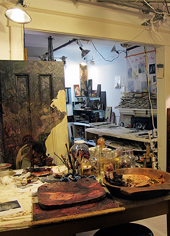 Image shows a room cluttered with artist's supplies