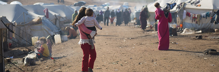 FEatured image shows refugees in a camp in syria