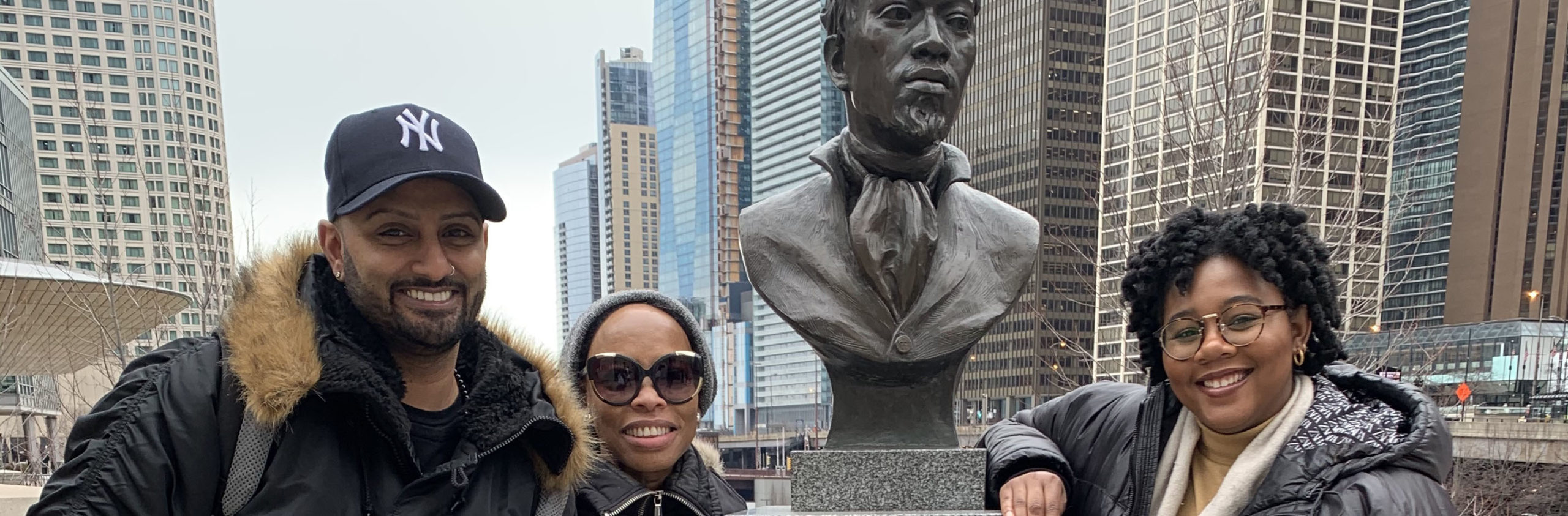 Arshad Desai, Andrea Davis and Aysha Campell with the bust of Jean-Baptiste Pointe DuSable, Founder of Chicago