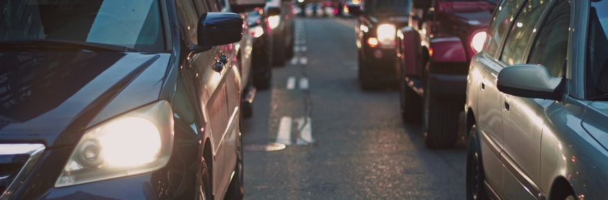 An image of cars lined up on a street in traffic