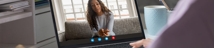 An image of a women using a laptop to video conference with another woman