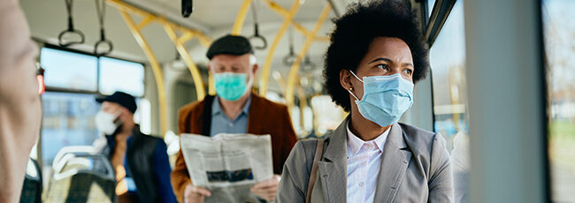 Woman wearing a pandemic mask while riding on public transit