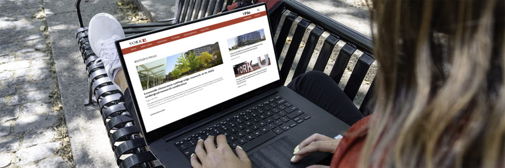 An image of a woman with a laptop that shows the YFile website