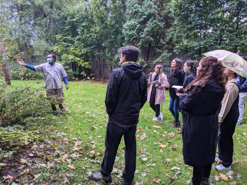 Sovann Muon (left) talks about a plant on York University's Glendon Campus during a tour of the grounds