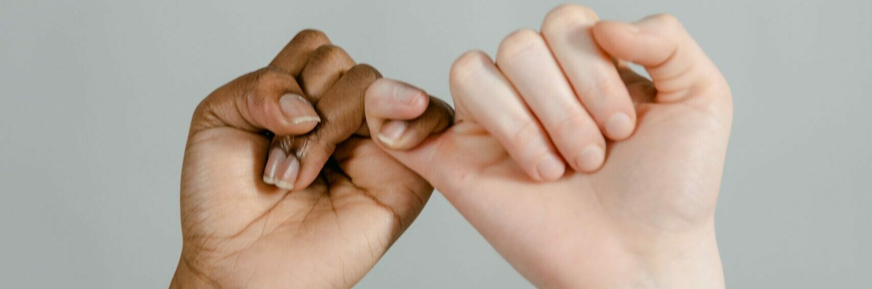 two people linking their pinky fingers