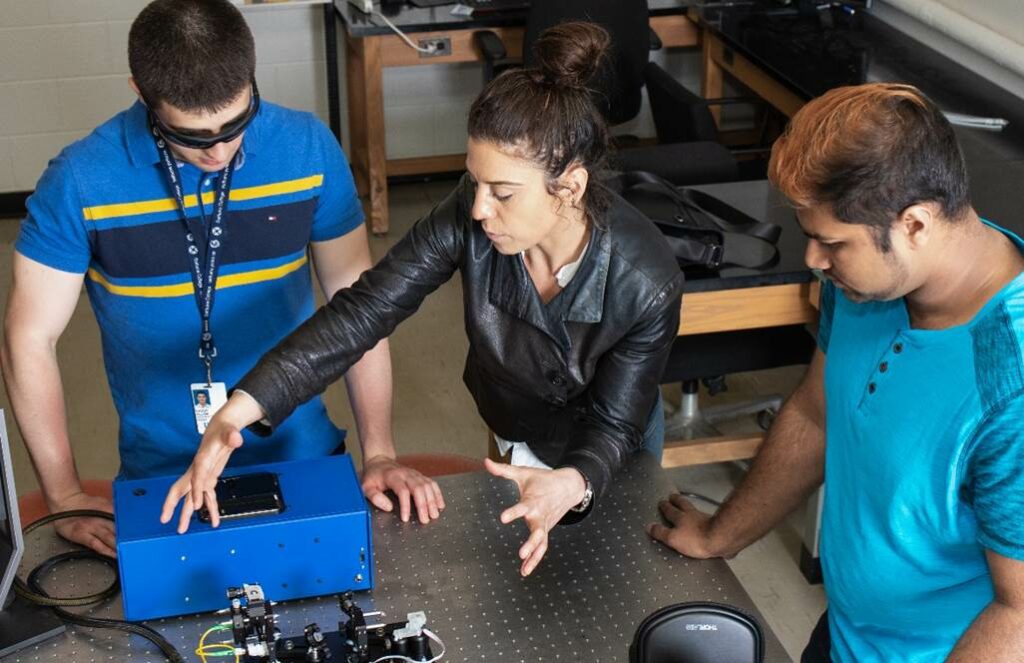 Ozzy Mermut works with students in her biophotonics lab