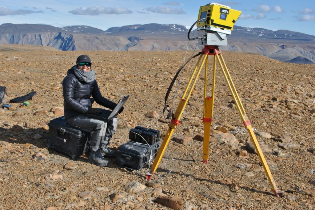 Chimira Andres conducting a ground-based LiDAR survey during a 2019 summer fieldwork campaign in the Mokka Fiord plateau, Axel Heiberg Island, Nunavut
