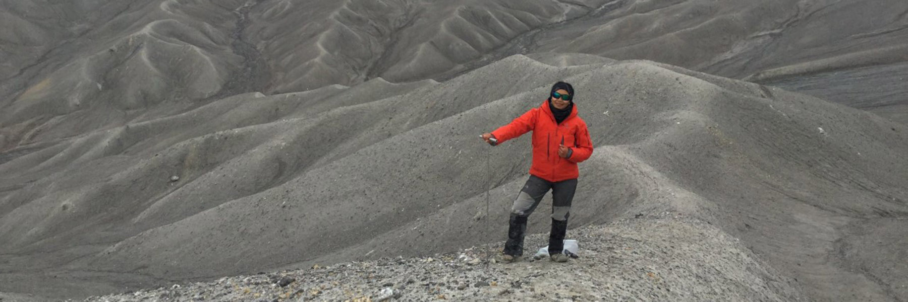 Chimira Andres in the Haughton Impact Structure, in Devon Island, Nunavut holding a permafrost probe during a 2019 summer fieldwork campaign