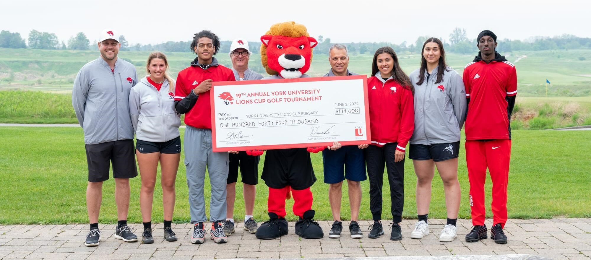 Lions mascot Yeo with dignitaries and student-athletes at the 19th annual Lions Cup golf tournament. From left: Bart Zemanek (associate director, advancement - Athletics & Recreation), Julia Cuccia (women's hockey player), Matthew Richards (track and field athlete), Guy Burry (co-chair, Lions Cup), Corrado Messina (senior relationship manager, Ontario Market Lead, TD Insurance), Lexy Anonech (women's hockey player), Alexis Grewal (women's basketball player), Abdullahi Abdullahi (track and field athlete)