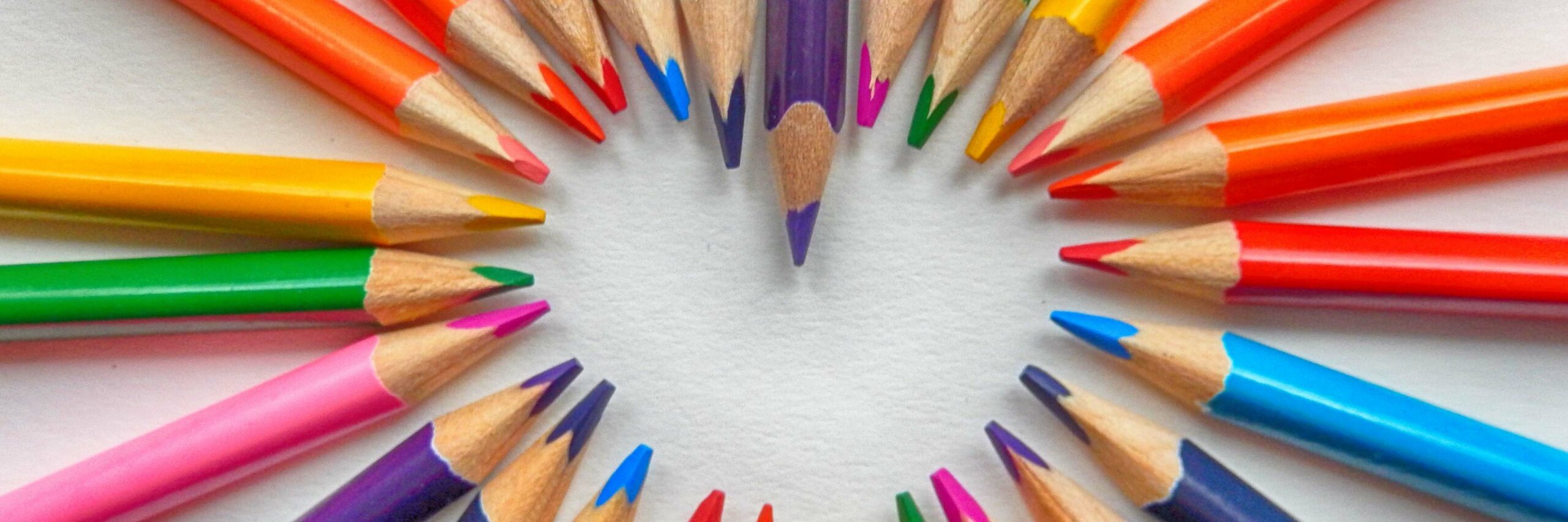 colourful pencil crayons form a heart