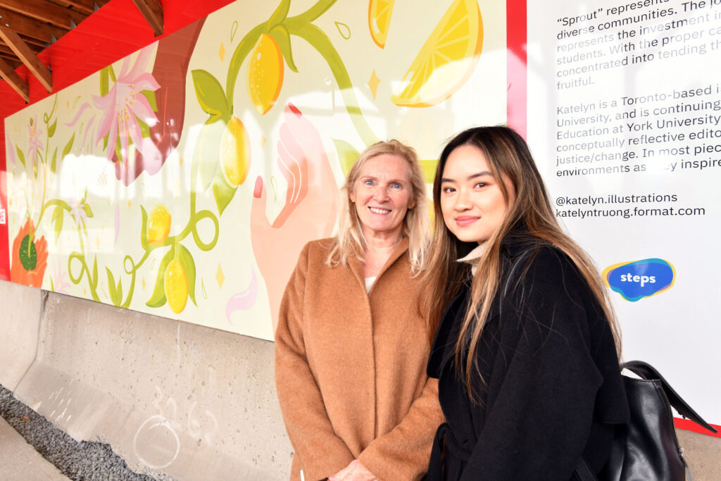 Current student Katelyn Truong pictured with York University President and Vice-Chancellor Rhonda Lenton in front of her selected artwork for the Markham Hoarding art installation