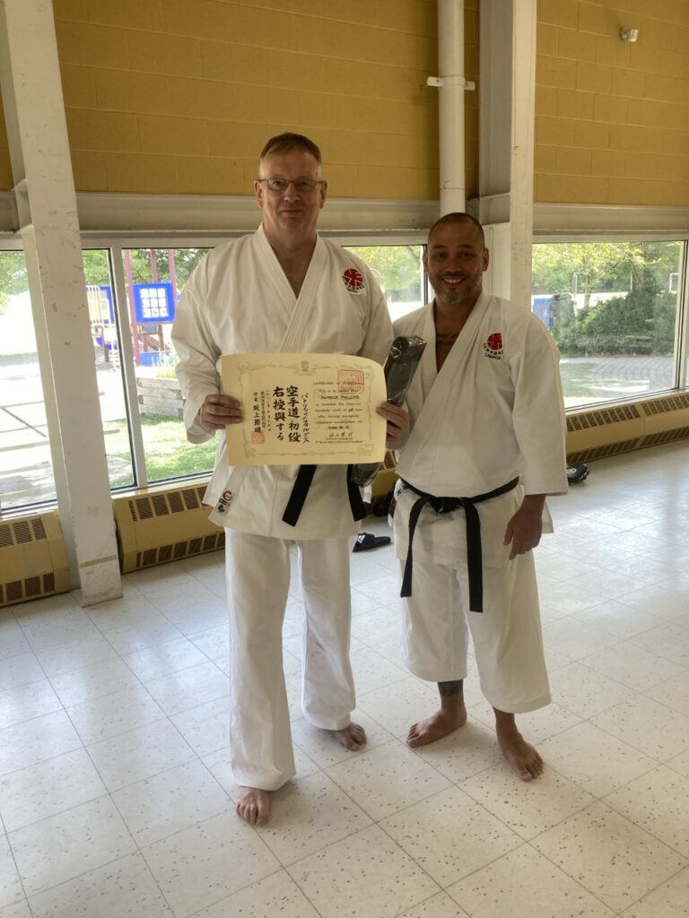 Phillips receiving black belt (Shodan) from Sensei Daniel Tsumura