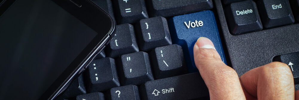 A keyboard with a key that says vote