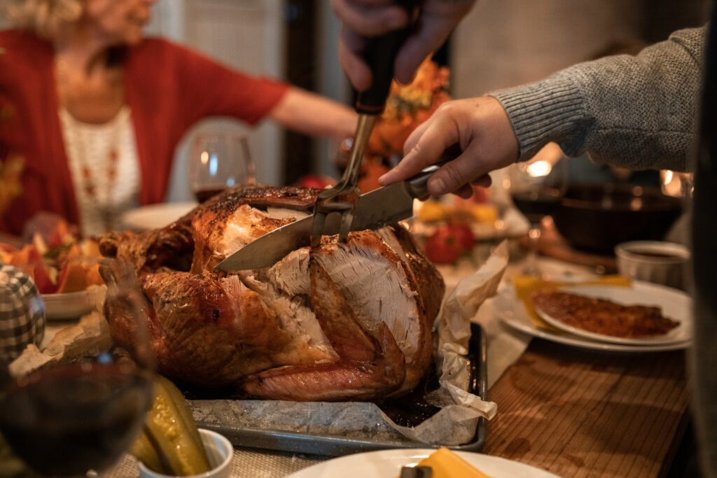Festive turkey being carved at a dinner table
