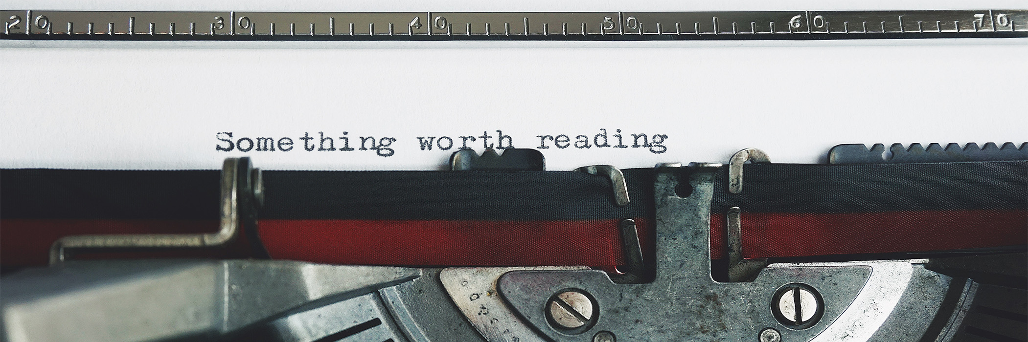 Typewriter typing "something worth reading"