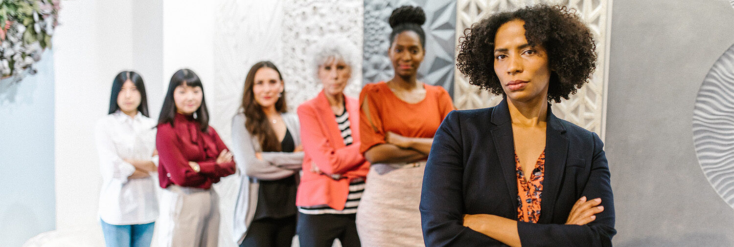 Group of women professionals posed boldly in office setting, stock image