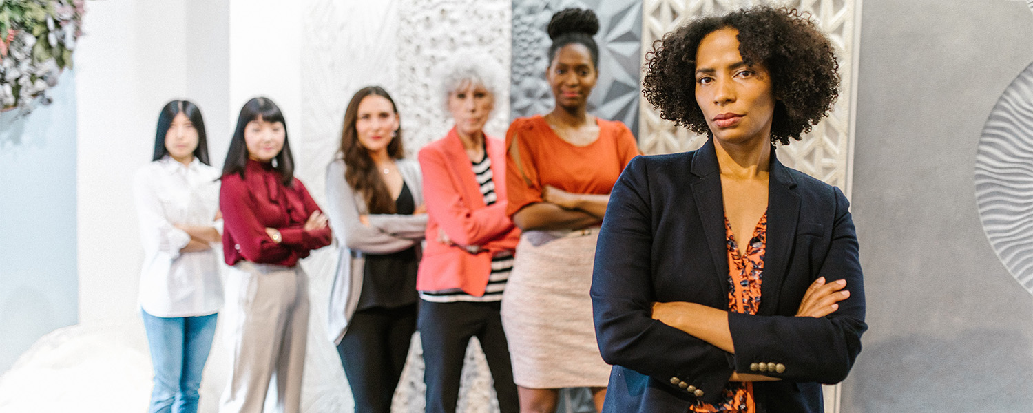 Group of women professionals posed boldly in office setting, stock image