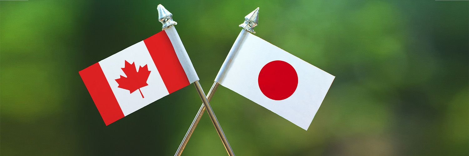 Miniature Canadian and Japanese flags crossed over each other
