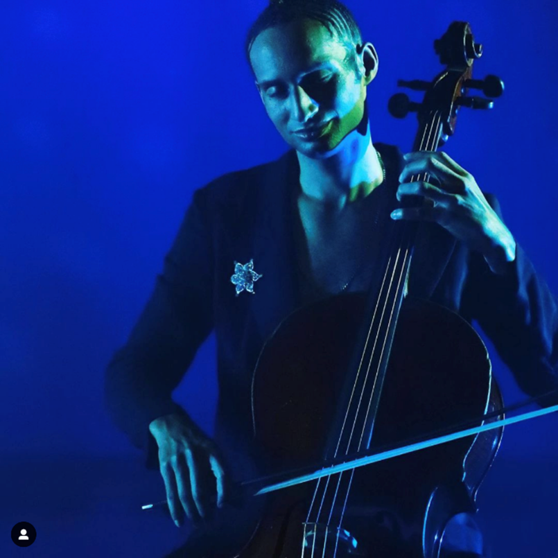 Artist Zeelie Brown holding cello under dramatic teal lighting