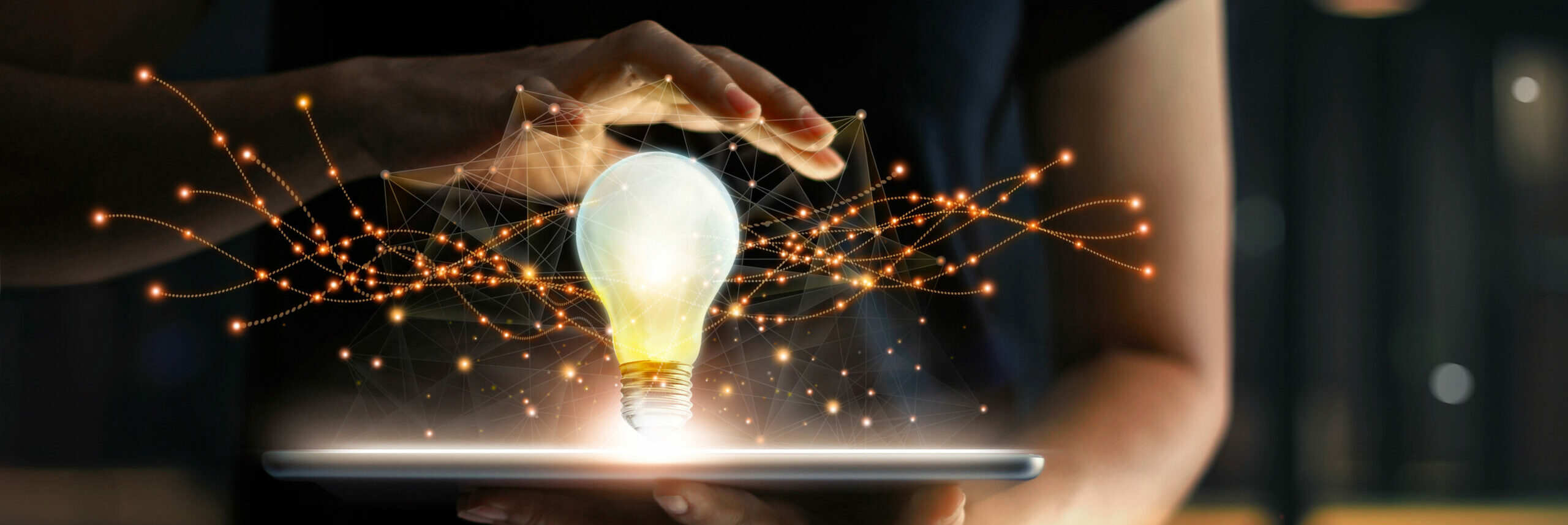 man using tablet with graphic image of lightbulb