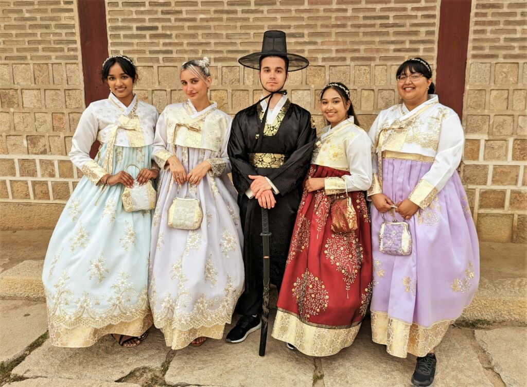 York students visiting Gyeongbokgung Palace dressed in traditional hanbok