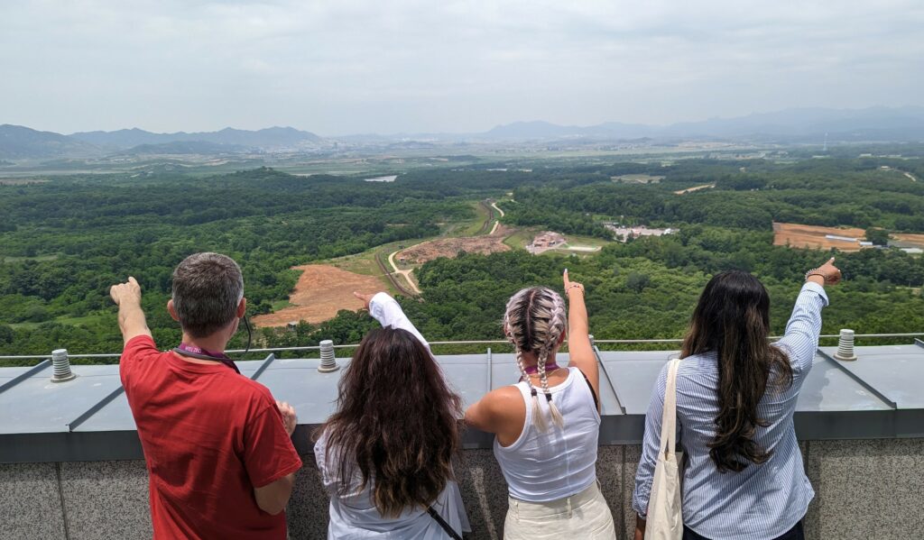 Klassen and students looking out onto the DMZ and North Korea