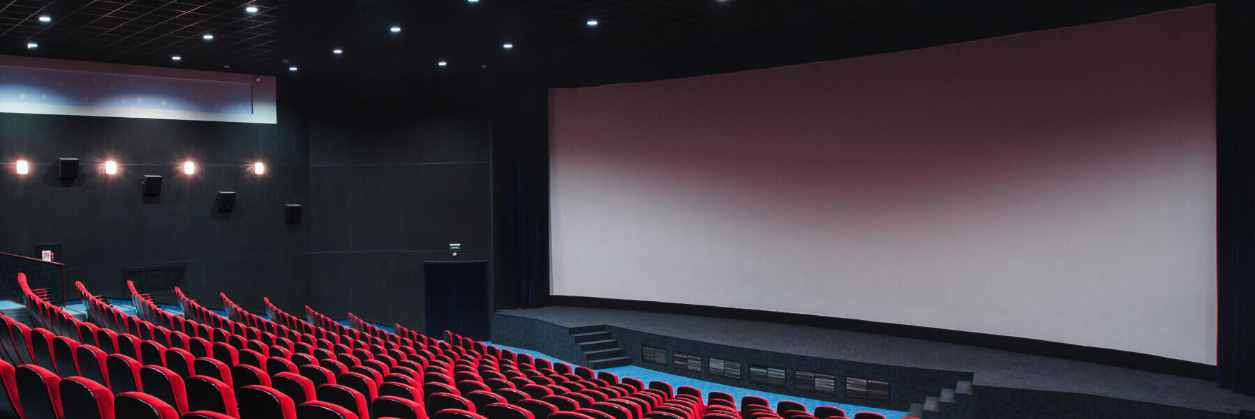 Empty cinema with red chairs