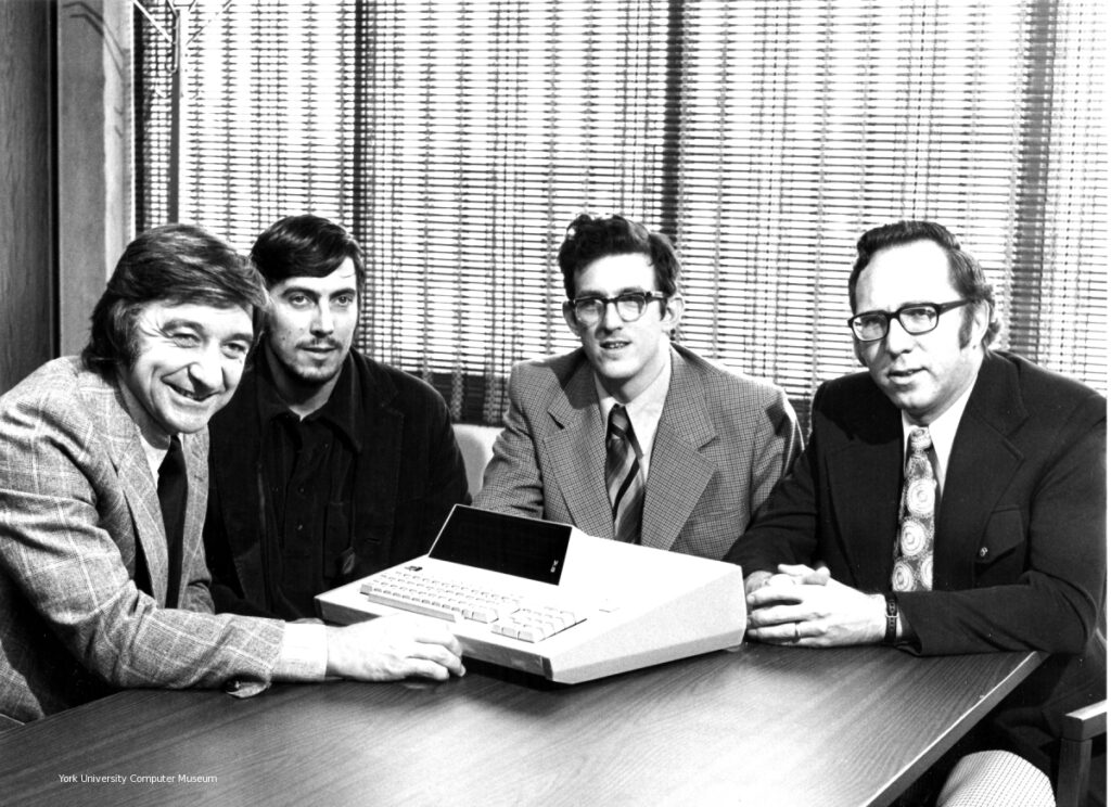 The Sept. 25, 1973 announcement of the MCM/70 in Toronto's Royal York Hotel (from left: Mers Kutt, Gordon Ramer, Edward (Ted) Edwards and Reg Rea with a prototype of the MCM/70. (Photo by Parkway Production courtesy of York University Computer Museum)