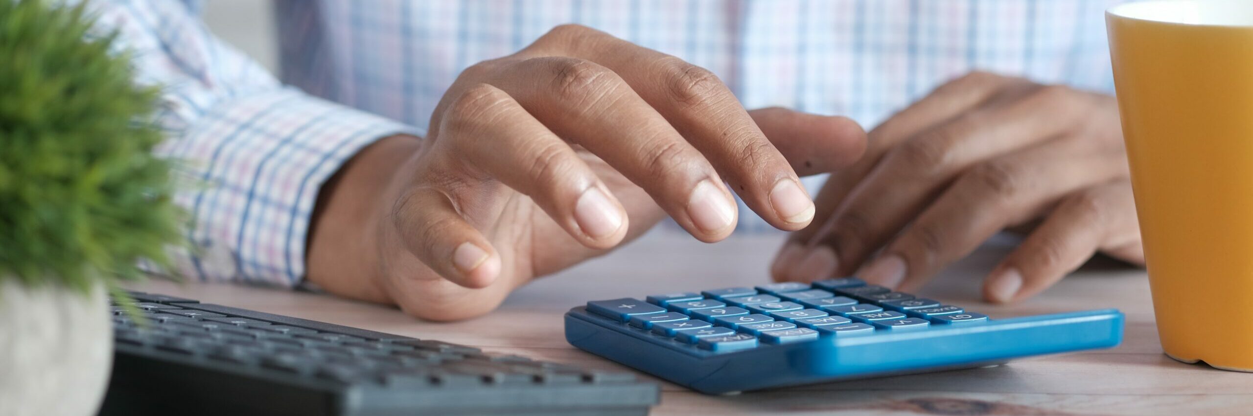 man using calculator finanace math