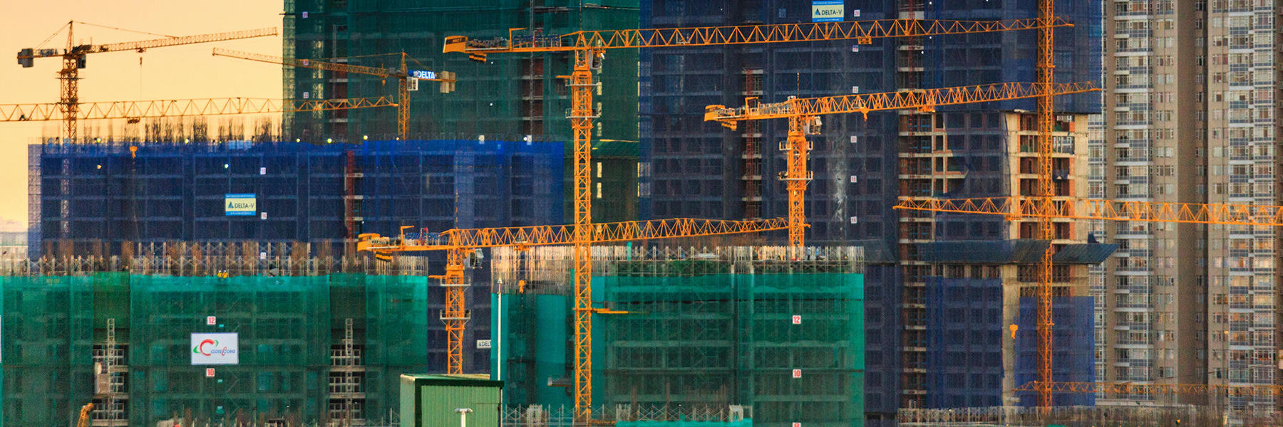 skyline of cranes construction infrastructure header