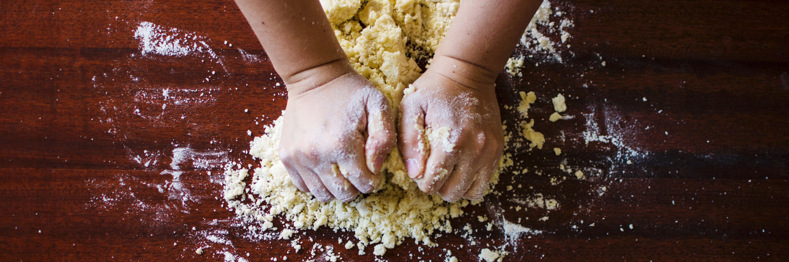 hands kneeding gluten free dough BANNER