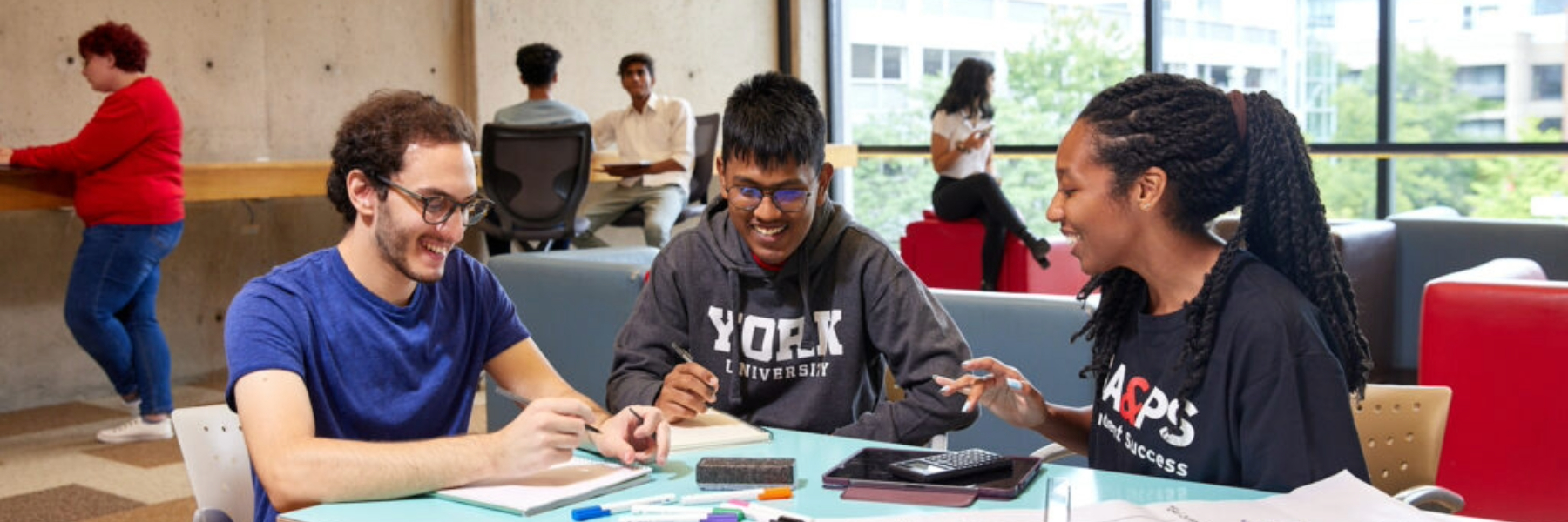 Three York University students collaborating on project