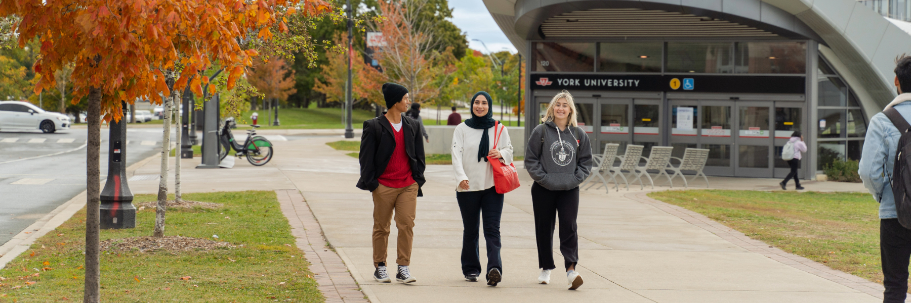 Three students walking on York's Keele Campus