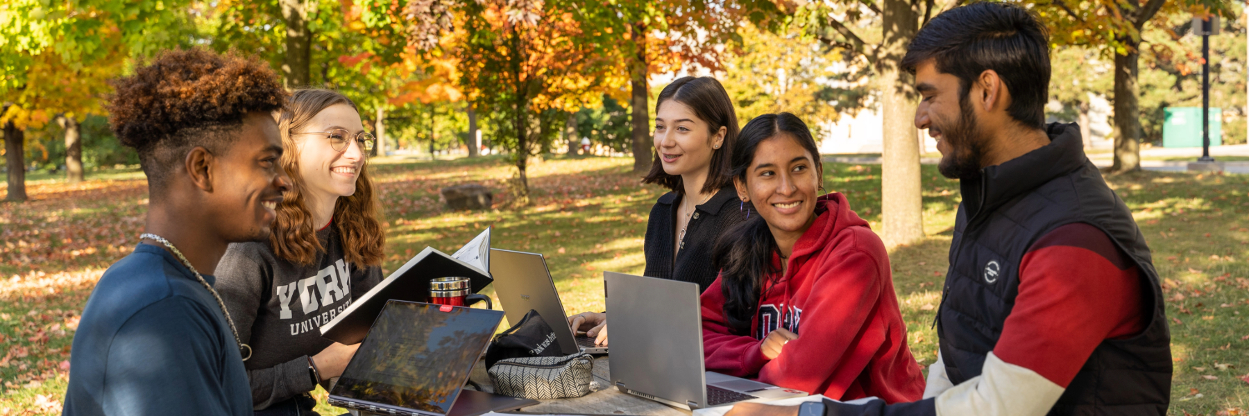 Students sitting at outdoor picnic table