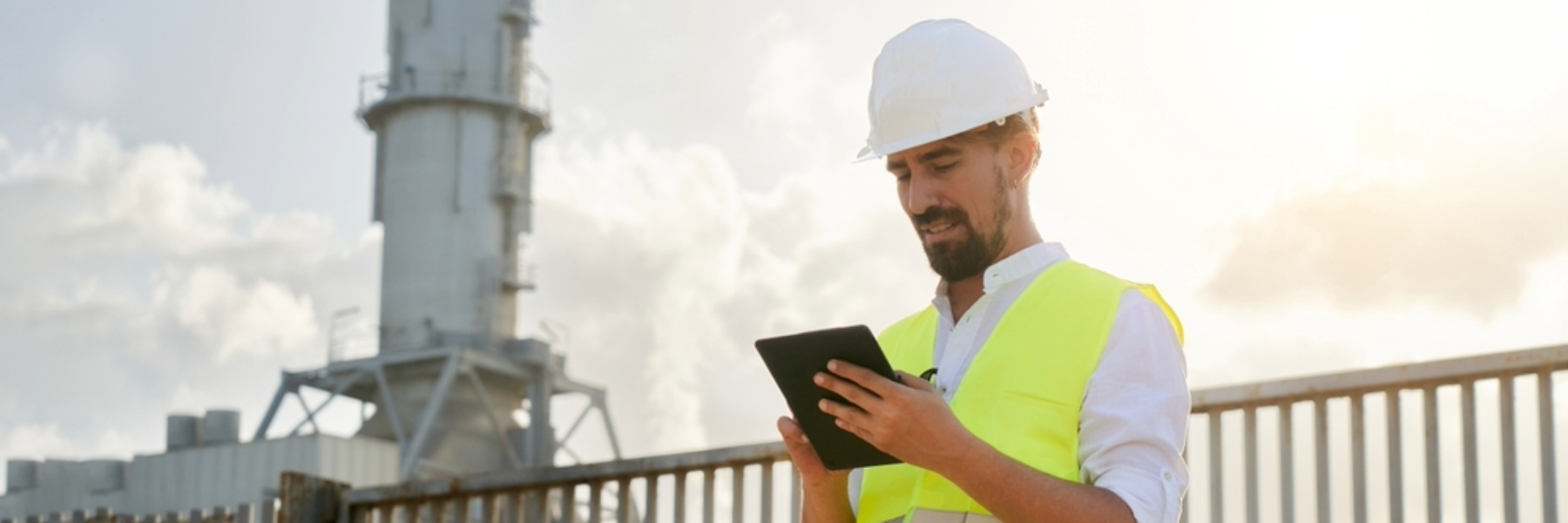 Engineer using tablet outside of energy generator plant