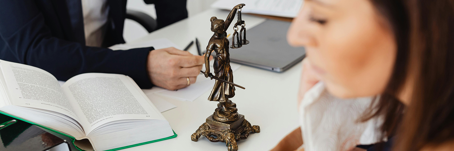 Lawyers working with Lady Justice looking on